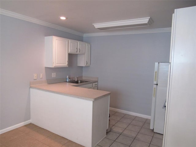 kitchen featuring sink, crown molding, white refrigerator, white cabinets, and light tile patterned flooring