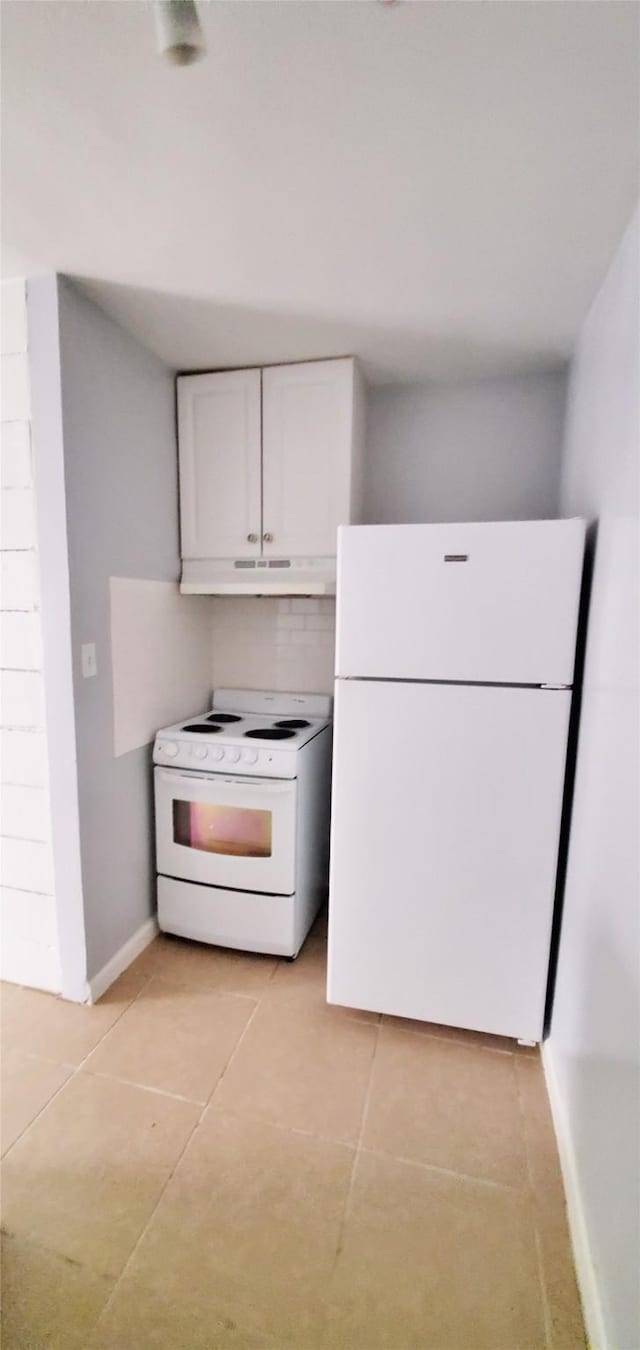 kitchen featuring light tile patterned floors, white cabinets, and white appliances