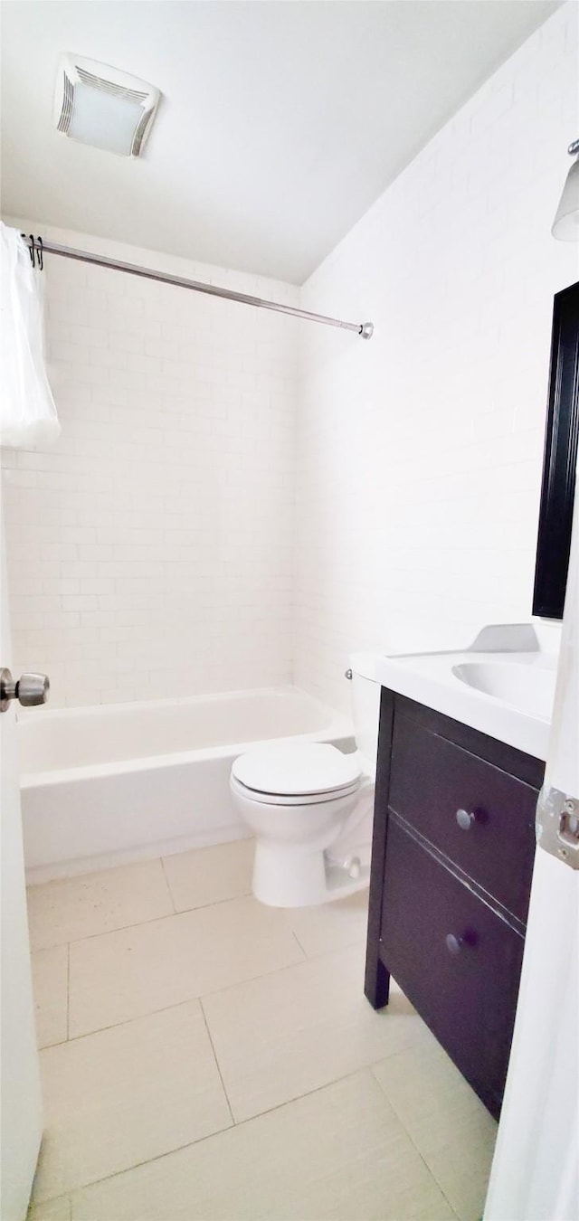 full bathroom featuring vanity, toilet, tiled shower / bath combo, and tile patterned flooring