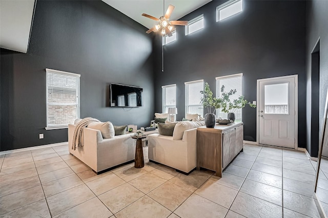 tiled living room with a towering ceiling and ceiling fan