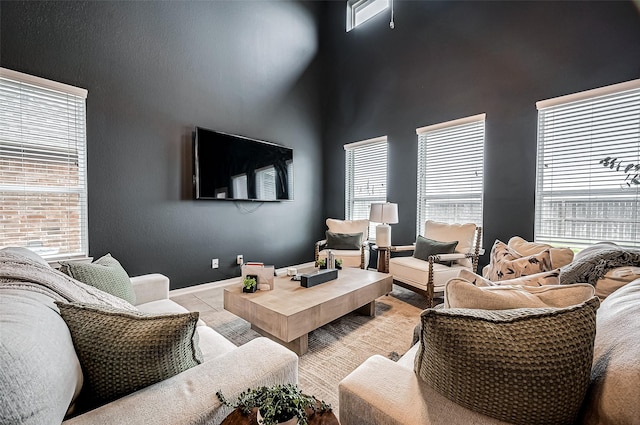 tiled living room with a towering ceiling