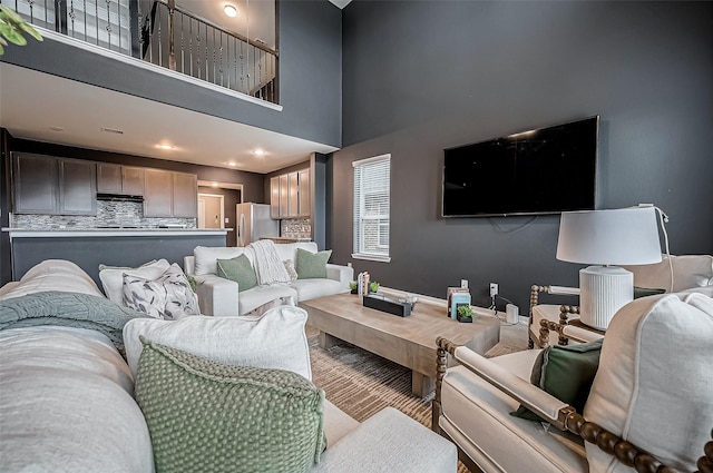 living room featuring a high ceiling