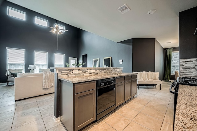 kitchen featuring light tile patterned floors, ceiling fan, backsplash, light stone counters, and black appliances