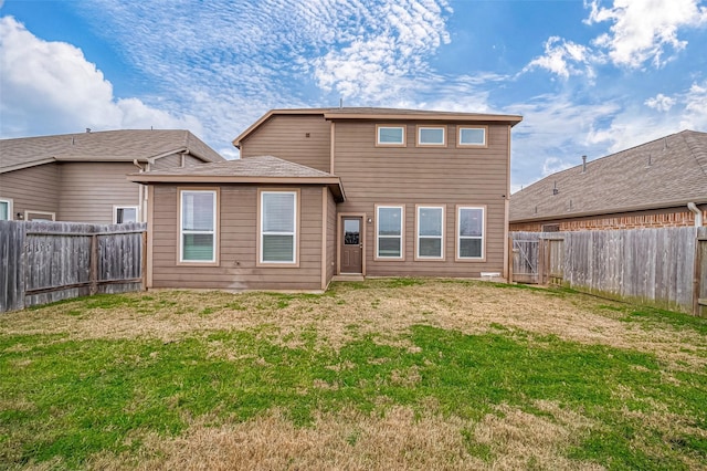 rear view of house featuring a yard