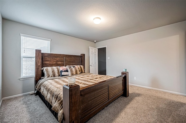 bedroom featuring carpet floors and a textured ceiling