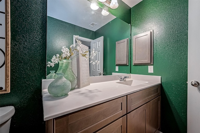 bathroom featuring vanity and toilet