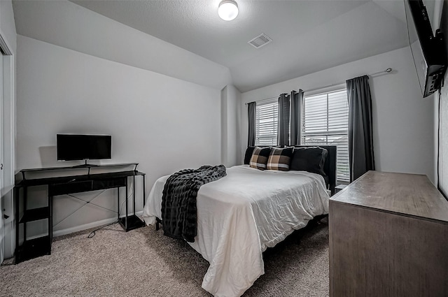 carpeted bedroom with vaulted ceiling