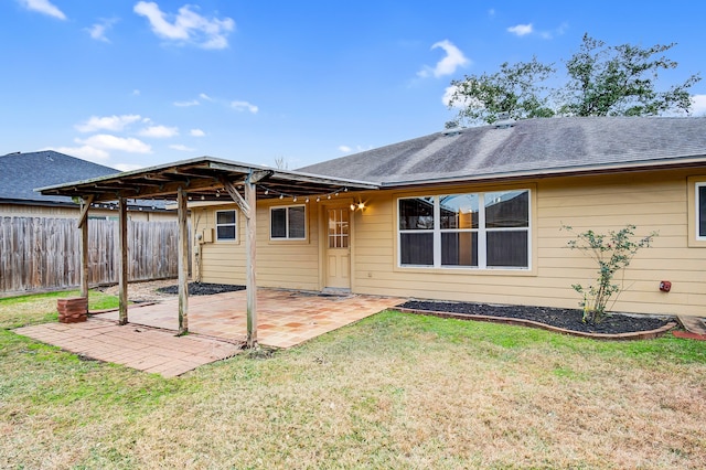 rear view of property featuring a patio area and a lawn