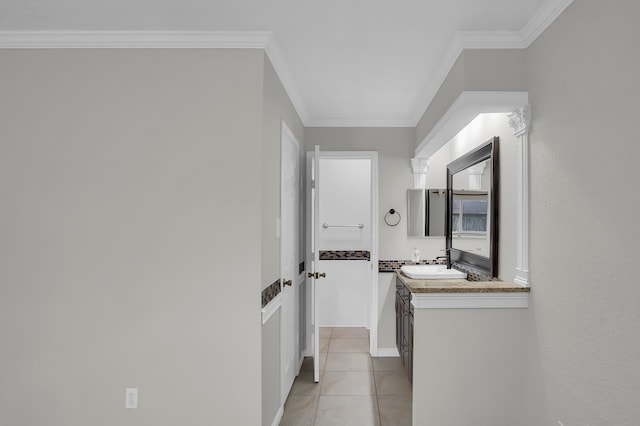 bathroom with tile patterned flooring, ornamental molding, and vanity