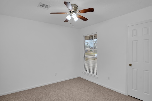 spare room featuring carpet flooring and ceiling fan