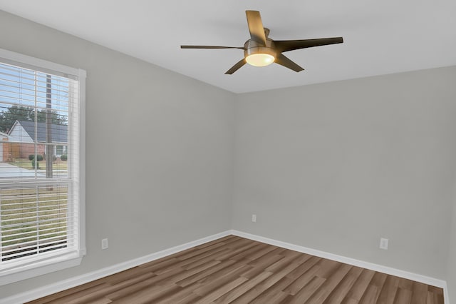 spare room featuring hardwood / wood-style flooring, a healthy amount of sunlight, and ceiling fan