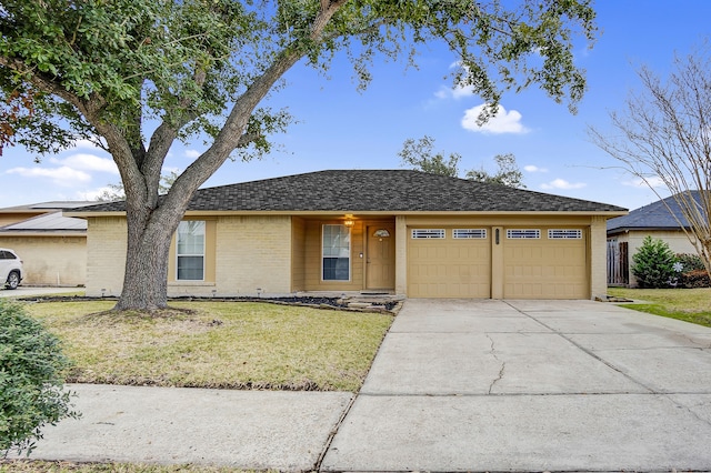 ranch-style house with a garage and a front lawn