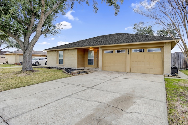 ranch-style home featuring a garage and a front lawn