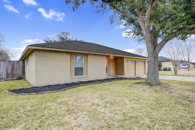 ranch-style house featuring a garage and a front lawn