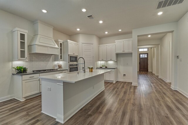 kitchen with a kitchen island with sink, white cabinetry, and appliances with stainless steel finishes