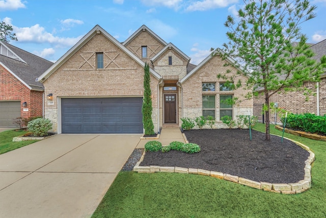 view of front of property with a garage and a front yard