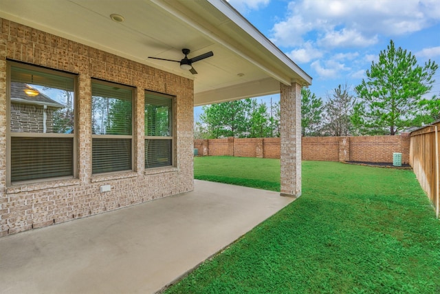 view of yard with ceiling fan and a patio area