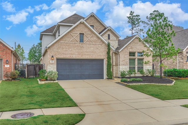 view of front of home with a garage and a front lawn