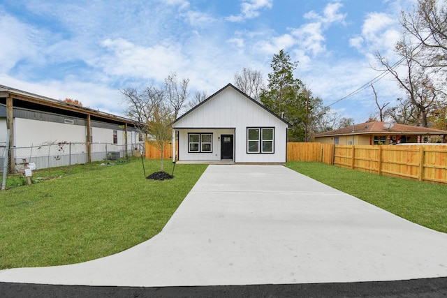 rear view of property featuring a lawn