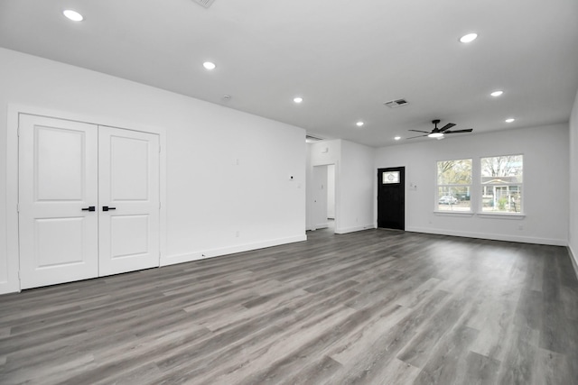 unfurnished living room with ceiling fan and wood-type flooring