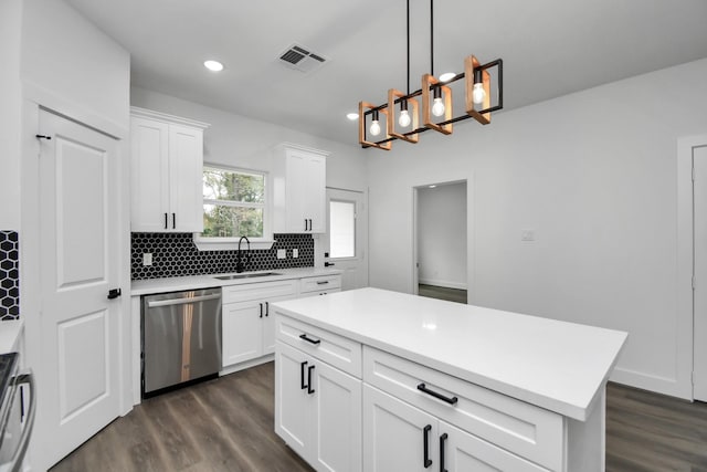 kitchen featuring white cabinetry, dishwasher, a kitchen island, and sink