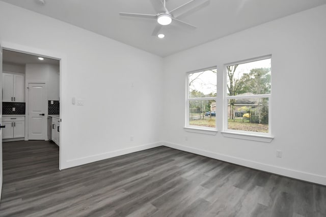 empty room featuring dark hardwood / wood-style floors and ceiling fan