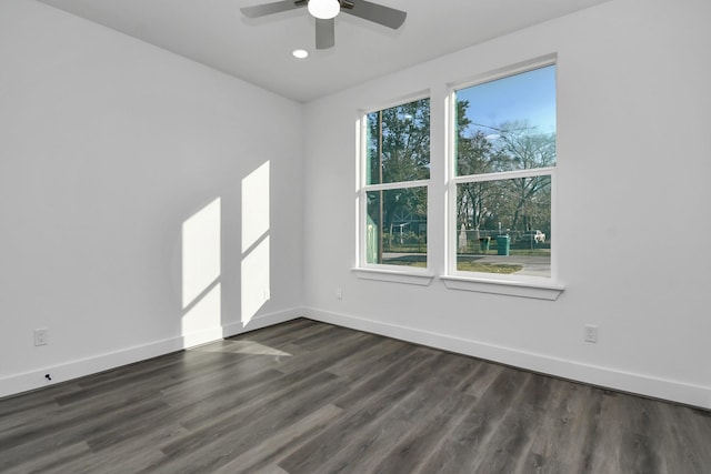 unfurnished room with ceiling fan and dark hardwood / wood-style flooring