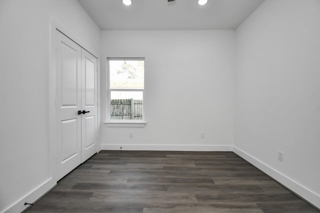 empty room with dark hardwood / wood-style flooring