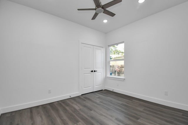 spare room with dark wood-type flooring and ceiling fan