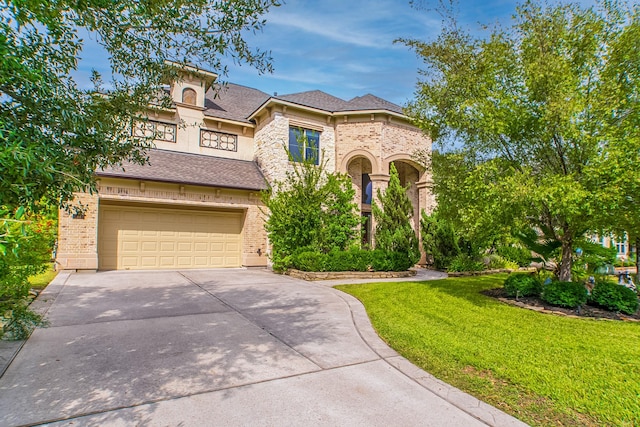 mediterranean / spanish-style home with a garage and a front lawn