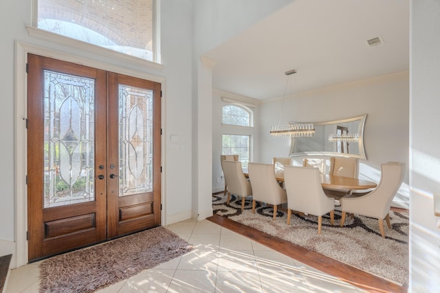 tiled entrance foyer featuring plenty of natural light and french doors