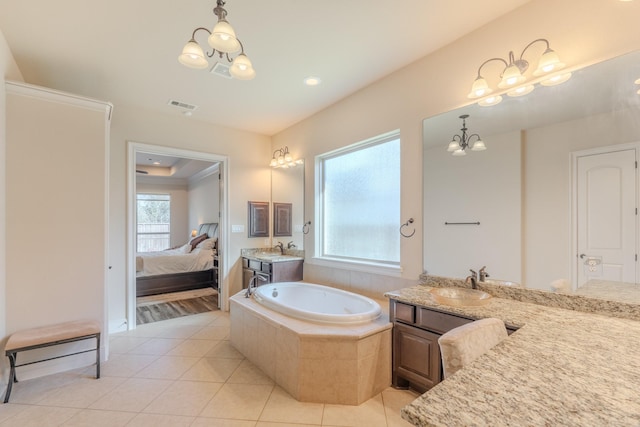 bathroom with tile patterned flooring, a notable chandelier, and vanity