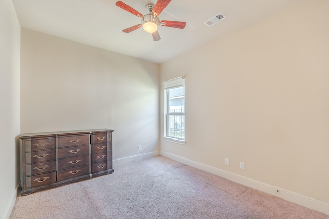 unfurnished bedroom with ceiling fan and light colored carpet