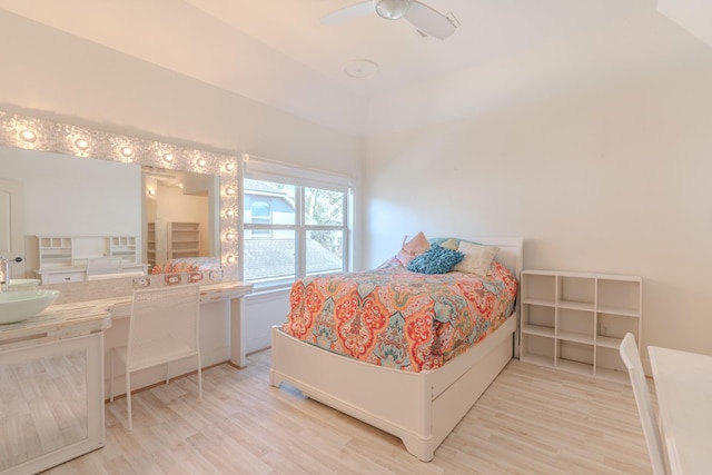 bedroom with wood-type flooring, sink, and ceiling fan