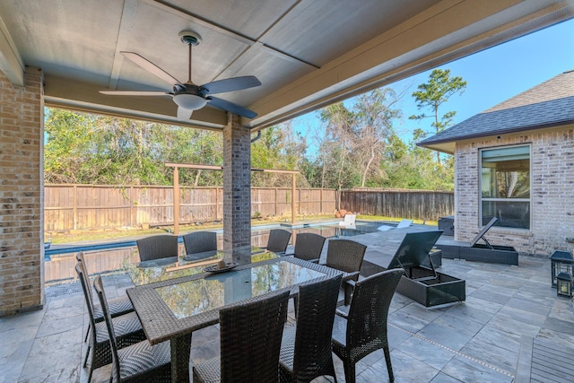 view of patio featuring ceiling fan and a fenced in pool