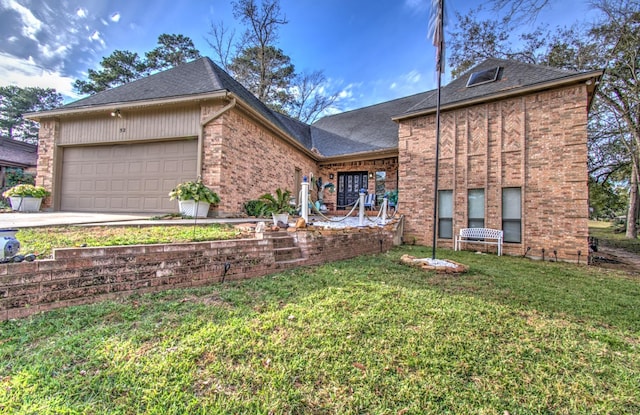 view of front of property with a garage and a front lawn