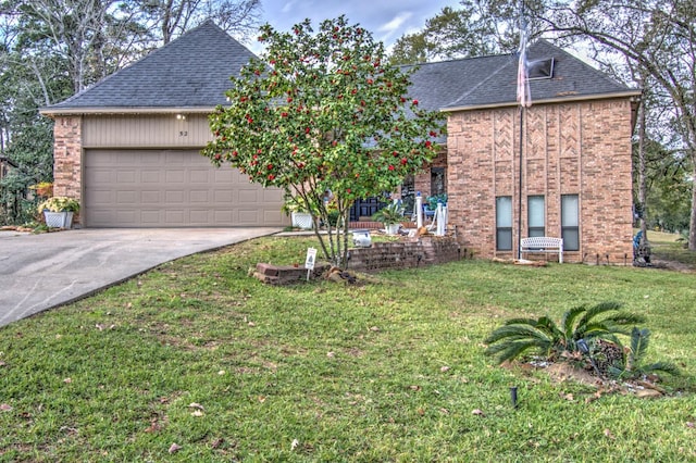 view of front of house featuring a garage and a front lawn