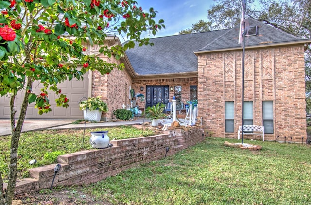 view of front facade with a garage and a front lawn