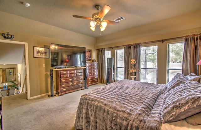 carpeted bedroom featuring access to exterior, a textured ceiling, and ceiling fan