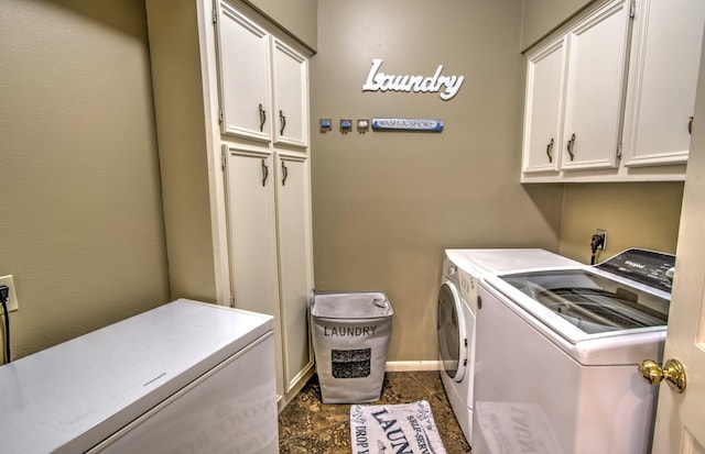 laundry room with washer and dryer and cabinets