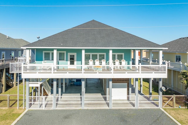 view of front of house with a garage, a balcony, a porch, and a carport