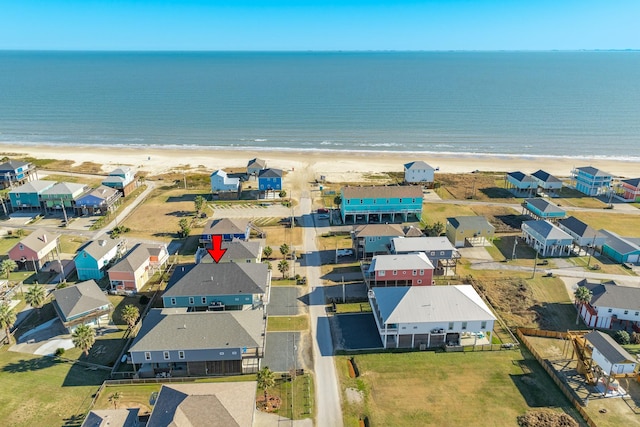 bird's eye view with a water view and a beach view