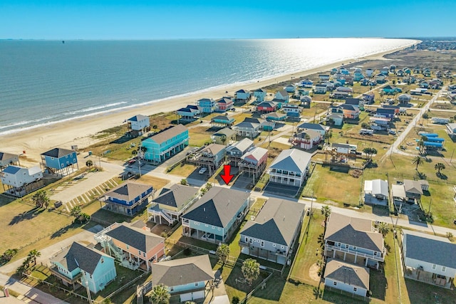 drone / aerial view featuring a beach view and a water view