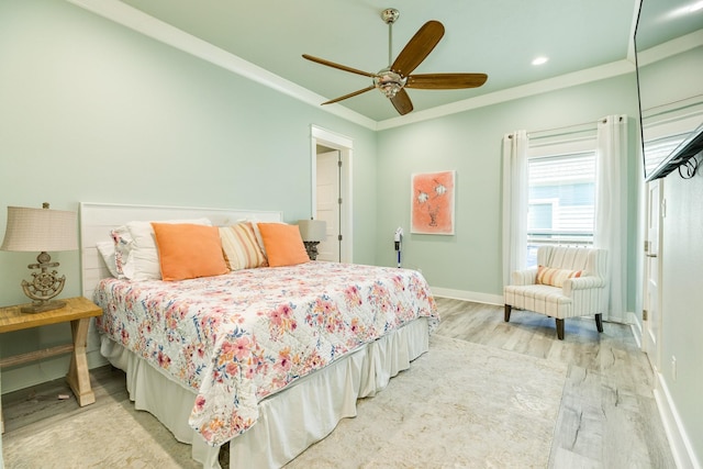 bedroom featuring crown molding, ceiling fan, and light hardwood / wood-style floors