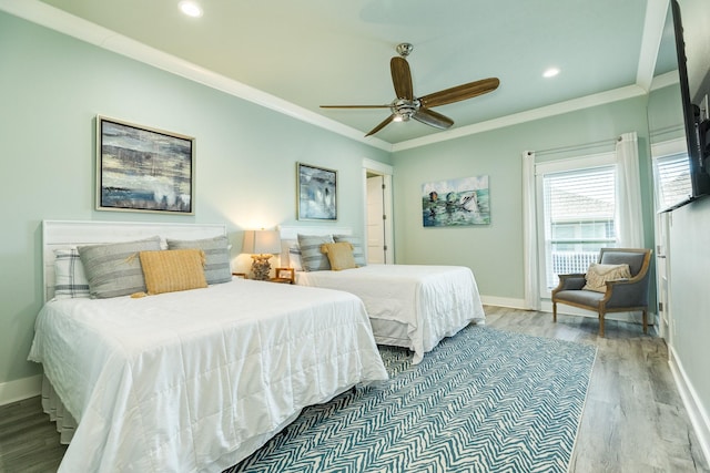 bedroom featuring crown molding, wood-type flooring, and ceiling fan