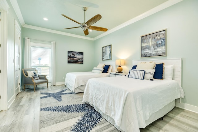 bedroom with ornamental molding, light hardwood / wood-style floors, and ceiling fan