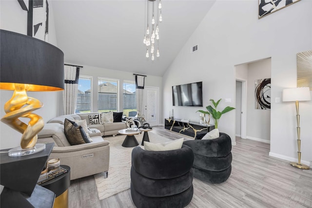 living room featuring a high ceiling and light hardwood / wood-style flooring