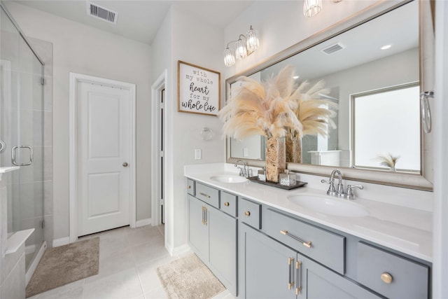 bathroom featuring tile patterned floors, an enclosed shower, and vanity