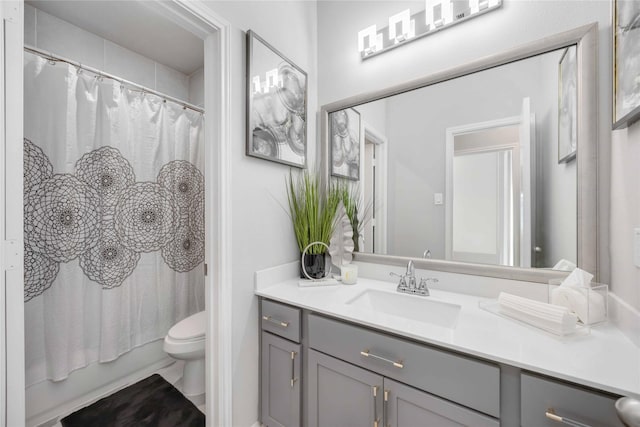 full bathroom with vanity, toilet, and shower / bath combo with shower curtain