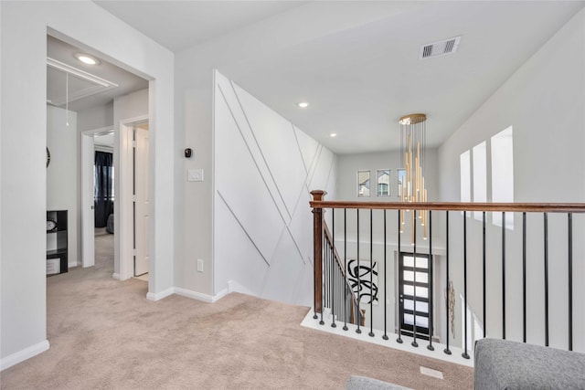 hall featuring light colored carpet